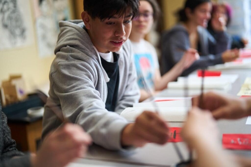 A group of students practice their Chinese writing.