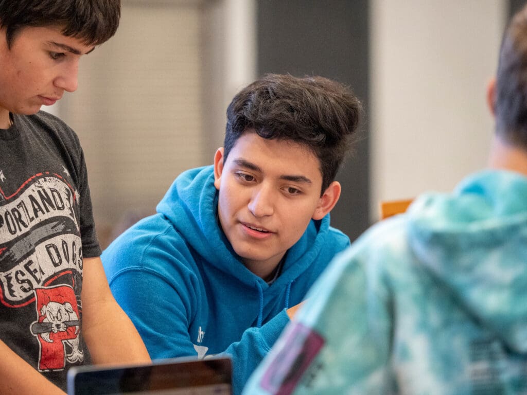 A student listens to his peers.